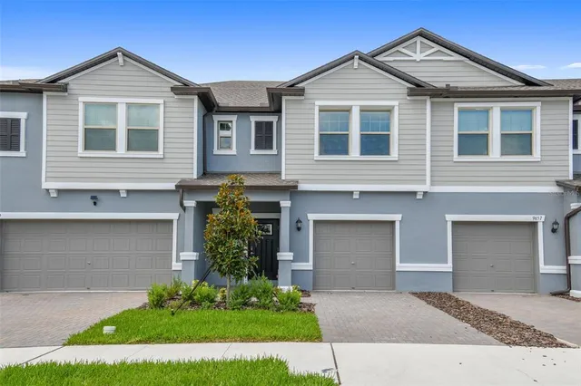 a front view of a house with a yard and garage