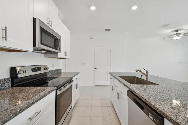 a view of an empty room with a ceiling fan