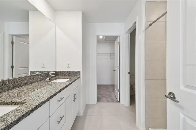 an aerial view of a house with a garden and houses