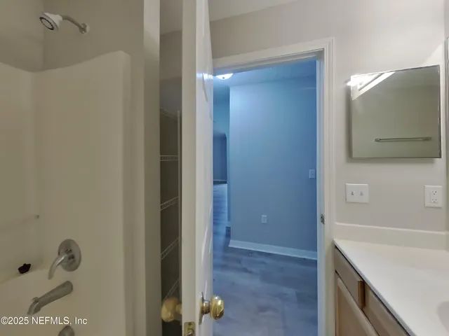 a bathroom with a shower and a sink