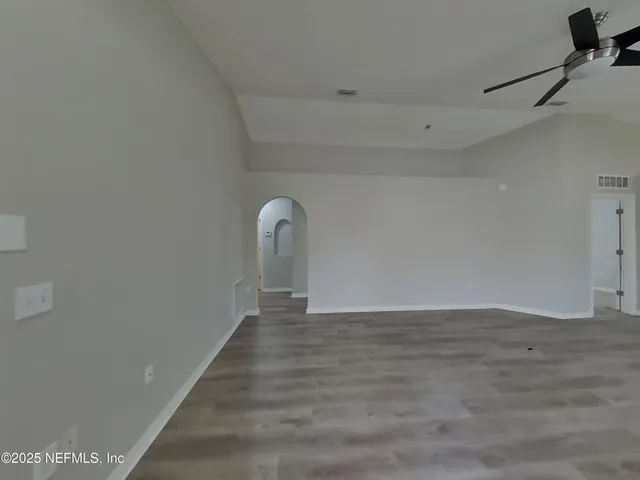 a view of a room with wooden floor