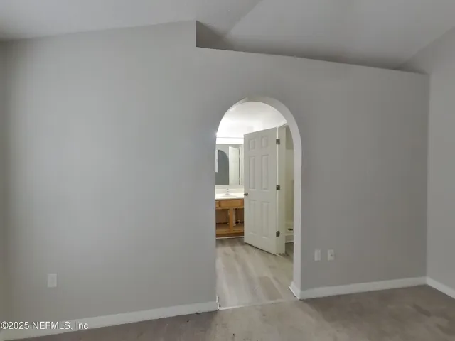 a view of a livingroom with wooden floor and a window