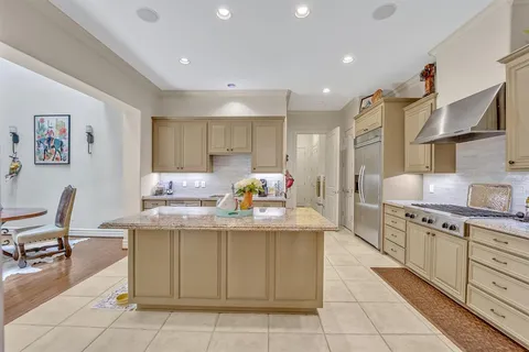 a kitchen with cabinets and chairs