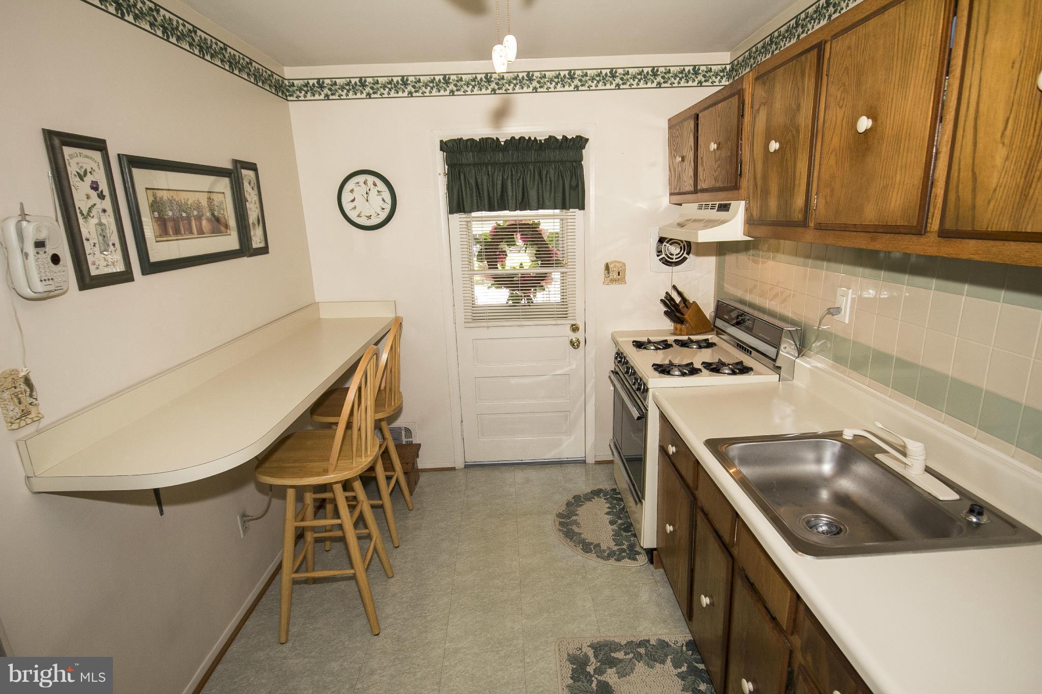 2136 Cockspur Road Baltimore, MD 21220 - Photo 2 of 20 a kitchen that has a sink and a stove in it
