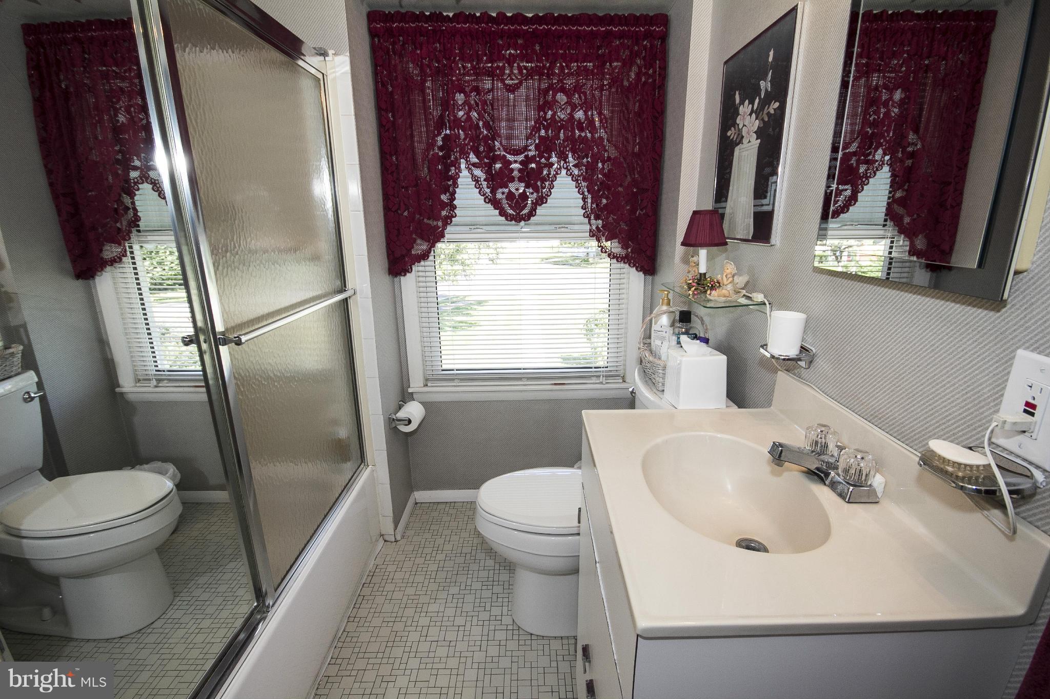 2136 Cockspur Road Baltimore, MD 21220 - Photo 12 of 20 a bathroom with a sink toilet and shower