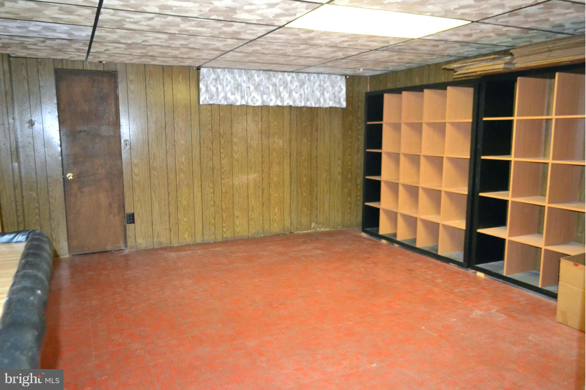 2136 Cockspur Road Baltimore, MD 21220 - Photo 14 of 20 a view of an empty room with a cabinet and bookshelf