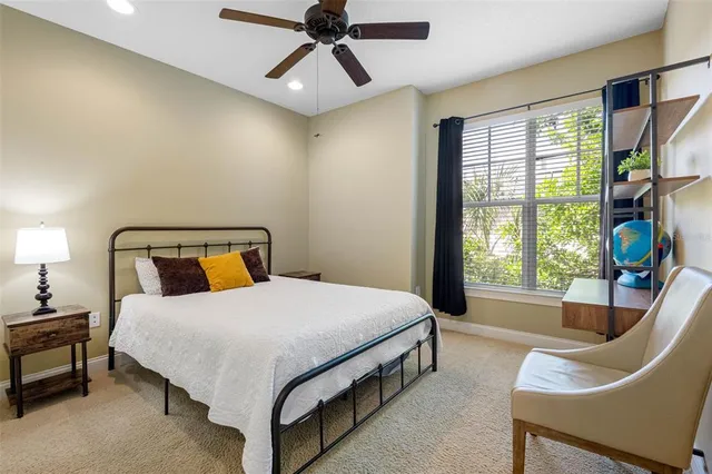 a bedroom with a bed chair and window