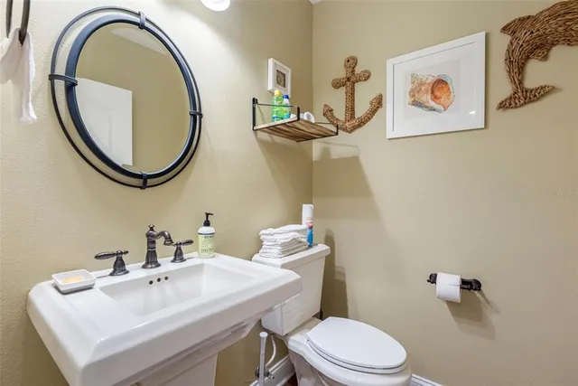 a bathroom with a sink mirror and toilet