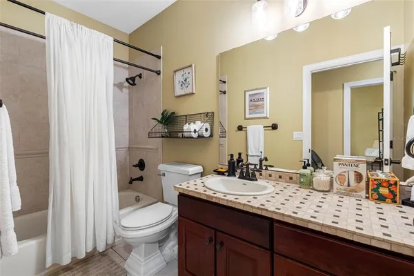 a bathroom with a double vanity sink toilet and shower