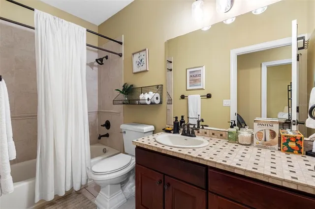 a bathroom with a double vanity sink toilet and shower