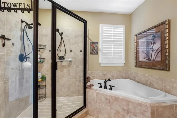 a bathroom with a tub a sink and a shower