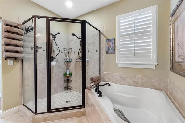 a bathroom with a tub and a shower