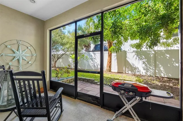 a view of a porch with furniture and a yard