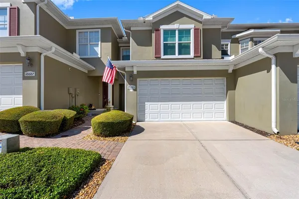 a front view of a house with a yard and garage