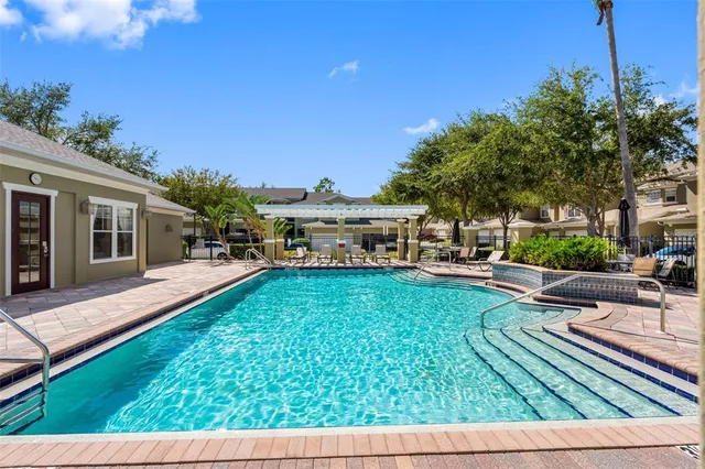 a view of a house with backyard porch and sitting area