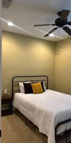 a bedroom with a bed and ceiling fan