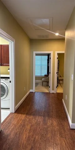 a view of a bedroom with a washer and dryer