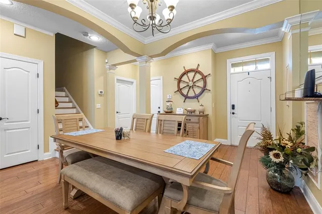 a dining room with furniture and wooden floor