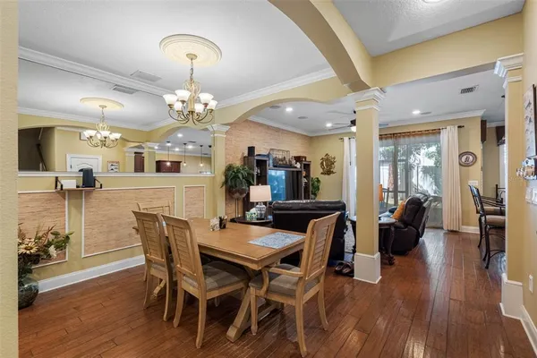 a view of a dining room with furniture and wooden floor