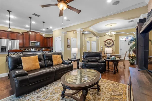 a living room with furniture a fireplace and a chandelier