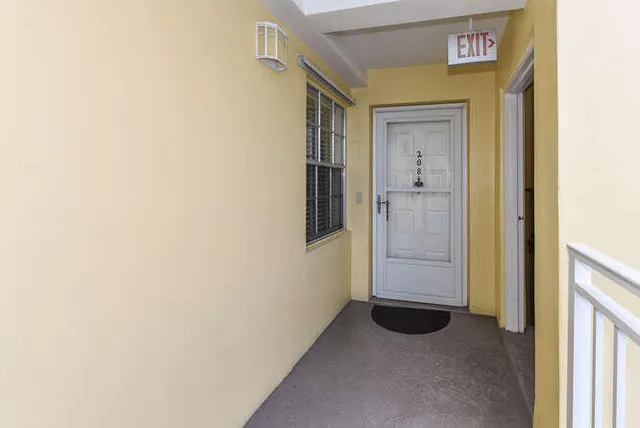 a view of a hallway with wooden floor and entryway