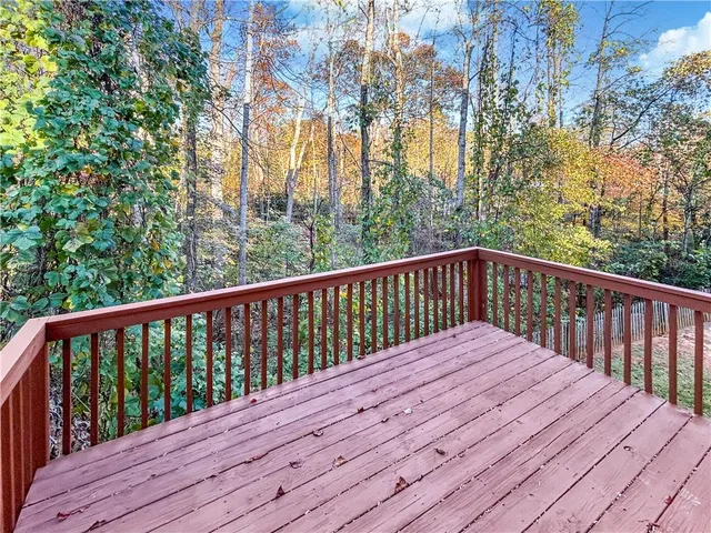 a view of balcony with wooden floor and fence