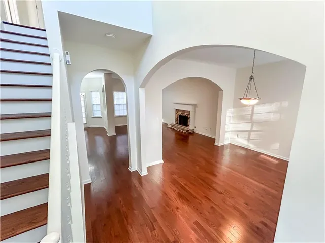 a view of livingroom and dining room with wooden floor