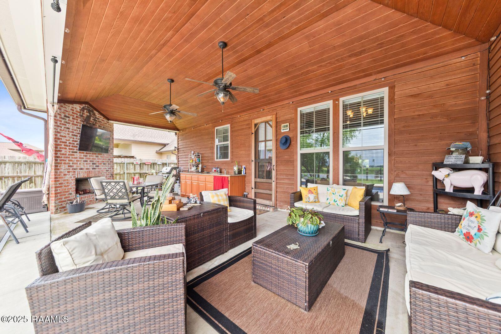 1181 Grand Loop Breaux Bridge, LA 70517 - Photo 21 of 40 Covered patio with wood burning fireplac