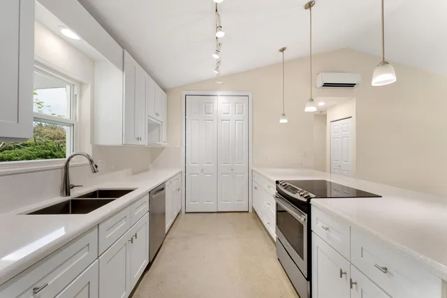 a kitchen with a sink stove and cabinets