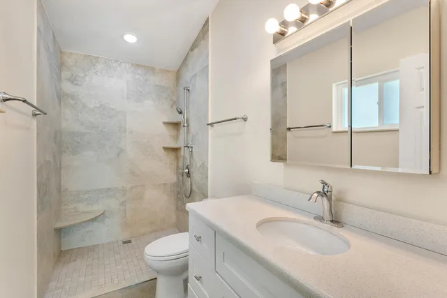 a bathroom with a sink toilet and shower