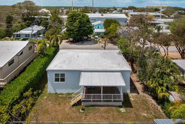 an aerial view of a house with a yard and balcony