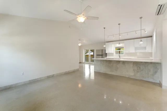a view of kitchen with kitchen island and stainless steel appliances