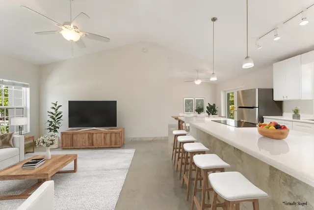 a dining room with furniture and a flat screen tv