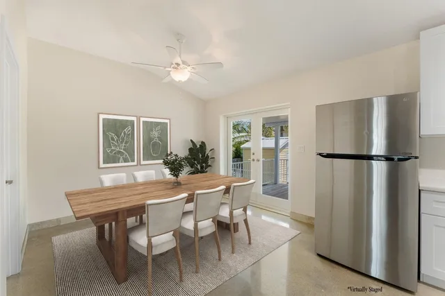 a dining room with furniture window entryway and wooden floor