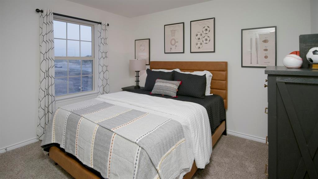500 Range Road Caddo Mills, TX 75135 - Photo 8 of 35 Bedroom featuring a window with grid pattern, neutral wall paint, and gray carpet flooring
