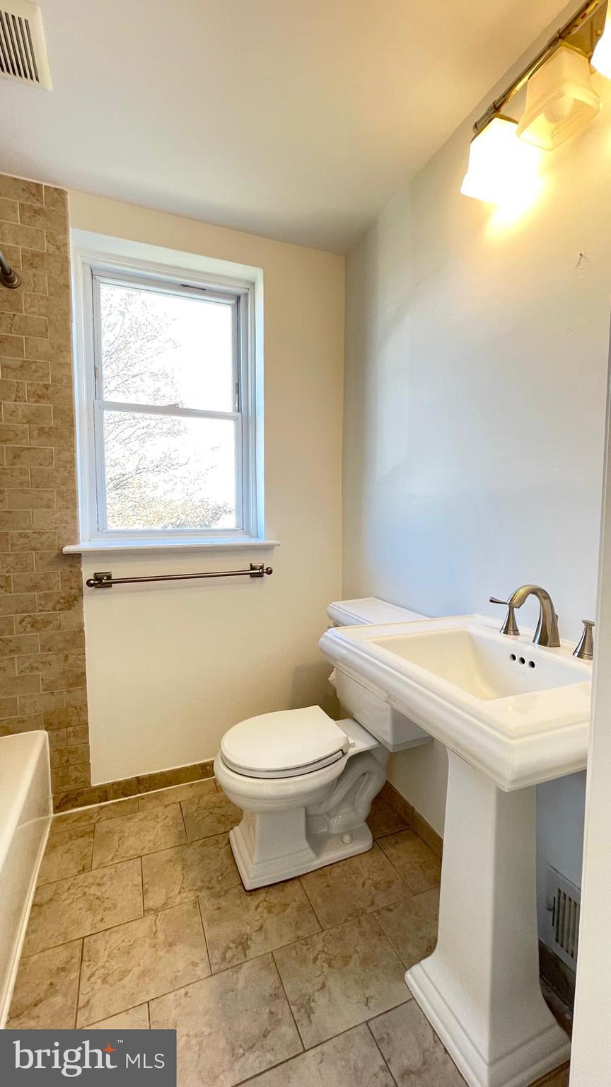 5358 Delmar Road Clifton Heights, PA 19018 - Photo 13 of 30 a bathroom with a sink a toilet and a window