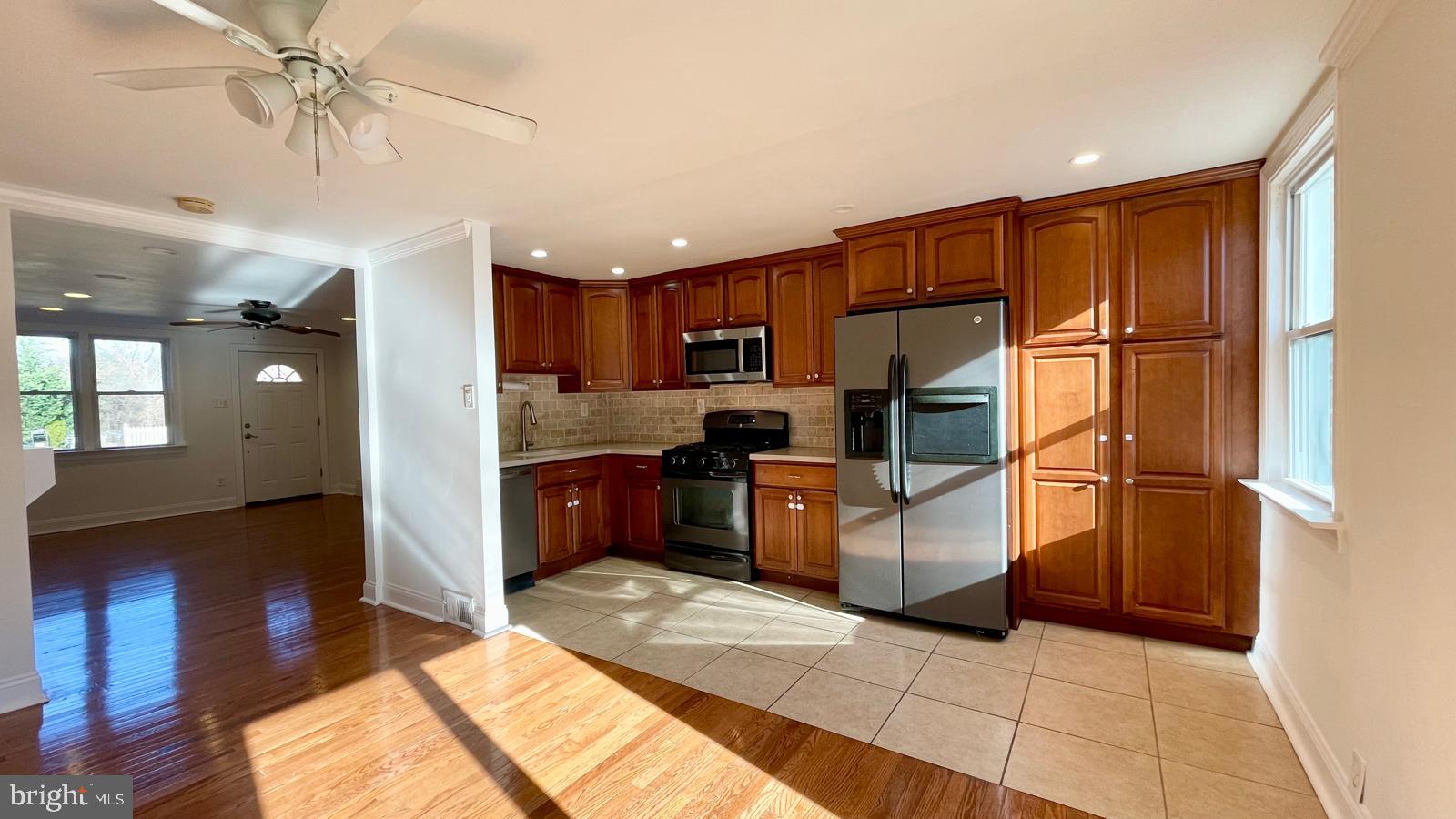 5358 Delmar Road Clifton Heights, PA 19018 - Photo 4 of 30 a kitchen with stainless steel appliances granite countertop a refrigerator oven a sink dishwasher and a refrigerator with wooden floor