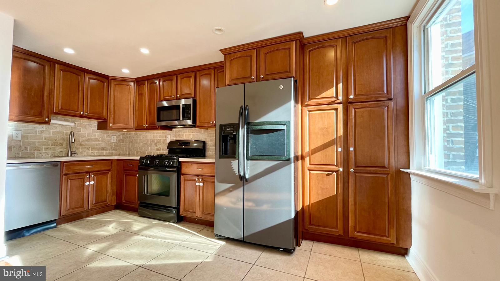 5358 Delmar Road Clifton Heights, PA 19018 - Photo 5 of 30 a kitchen with stainless steel appliances granite countertop a refrigerator sink and stove