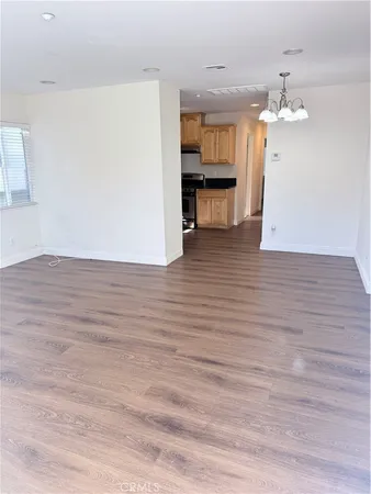 a kitchen with granite countertop wooden cabinets and a stove