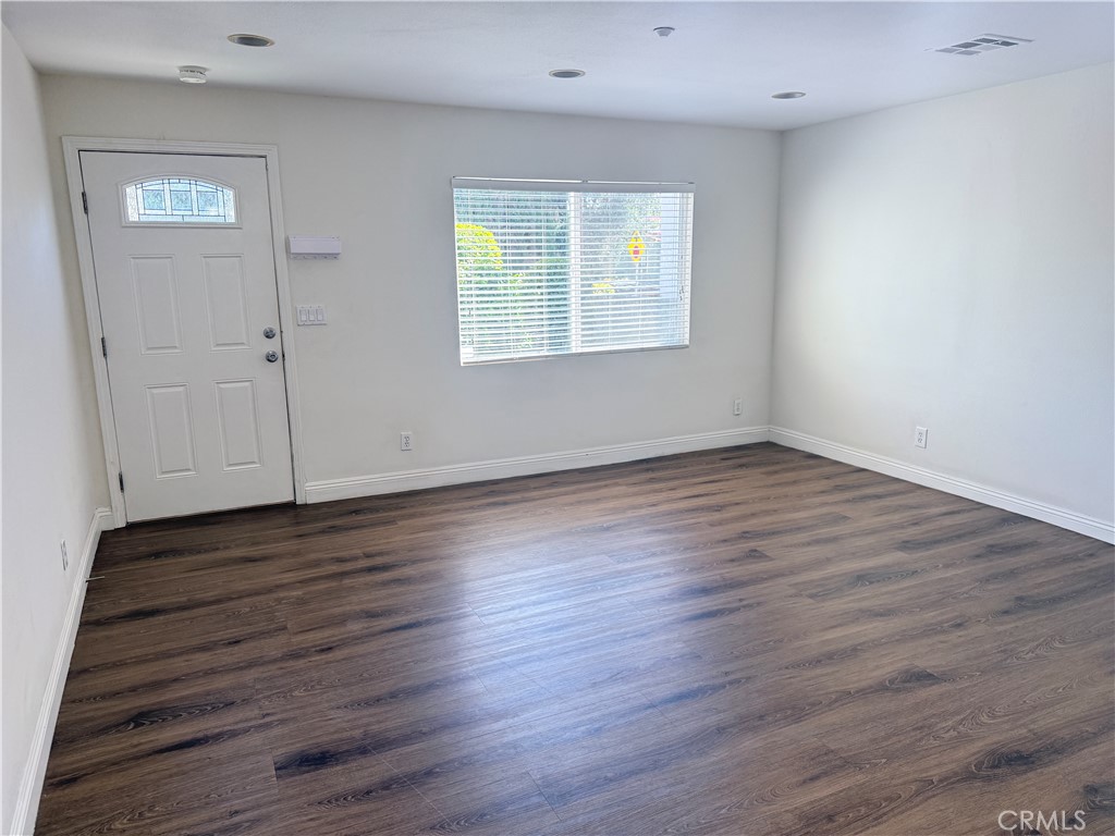 1025 Edith Avenue Alhambra, CA 91803 - Photo 7 of 11 a view of an empty room with wooden floor and a window