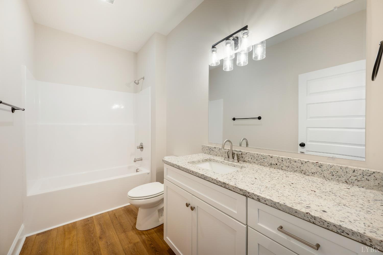 10556 Leesville Road Lynch Station, VA 24571 - Photo 6 of 64 a bathroom with a granite countertop sink a toilet and bathtub