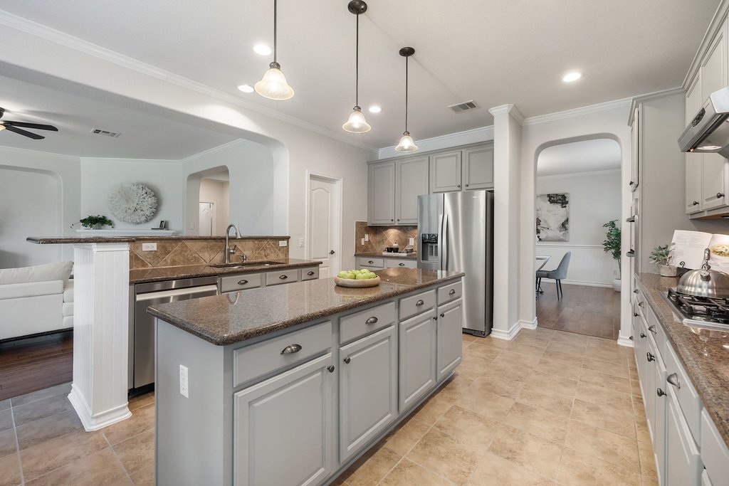 11129 Bastogne Loop Austin, TX 78739 - Photo 10 of 40 This kitchen feels so fresh and easy to live in. The soft freshly painted cabinetry, warm granite countertops, and clean white walls create a look that feels updated, timeless, and completely move-in ready.