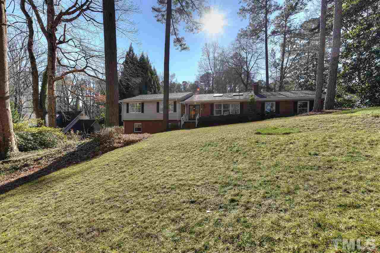 4217 Juniper Street Raleigh, NC 27612 - Photo 1 of 12 a front view of a house with a yard and trees