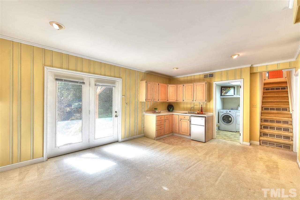 4217 Juniper Street Raleigh, NC 27612 - Photo 12 of 12 a view of a kitchen with a sink and a refrigerator