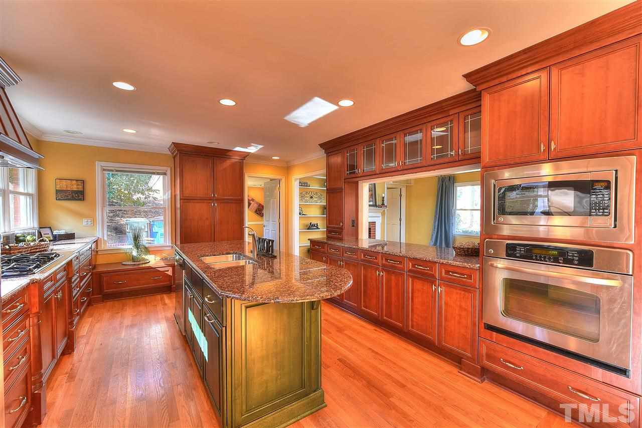 4217 Juniper Street Raleigh, NC 27612 - Photo 3 of 12 a kitchen with stainless steel appliances granite countertop a stove and more cabinets