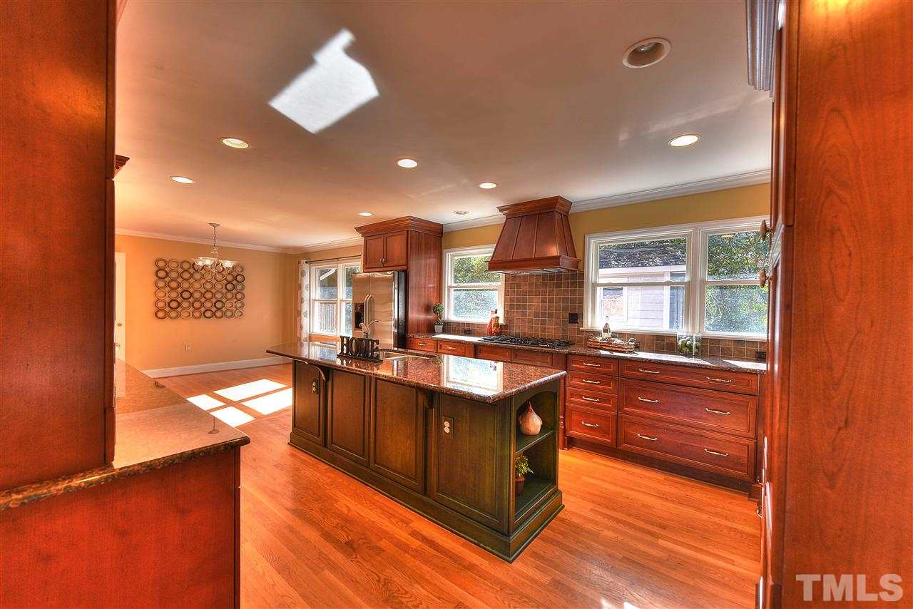 4217 Juniper Street Raleigh, NC 27612 - Photo 4 of 12 a kitchen with stainless steel appliances granite countertop a stove and a sink