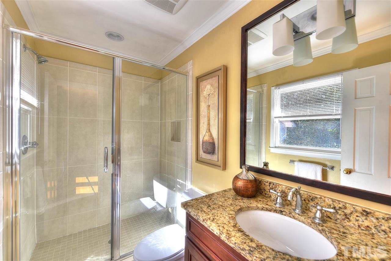 4217 Juniper Street Raleigh, NC 27612 - Photo 5 of 12 a bathroom with a granite countertop sink and a mirror