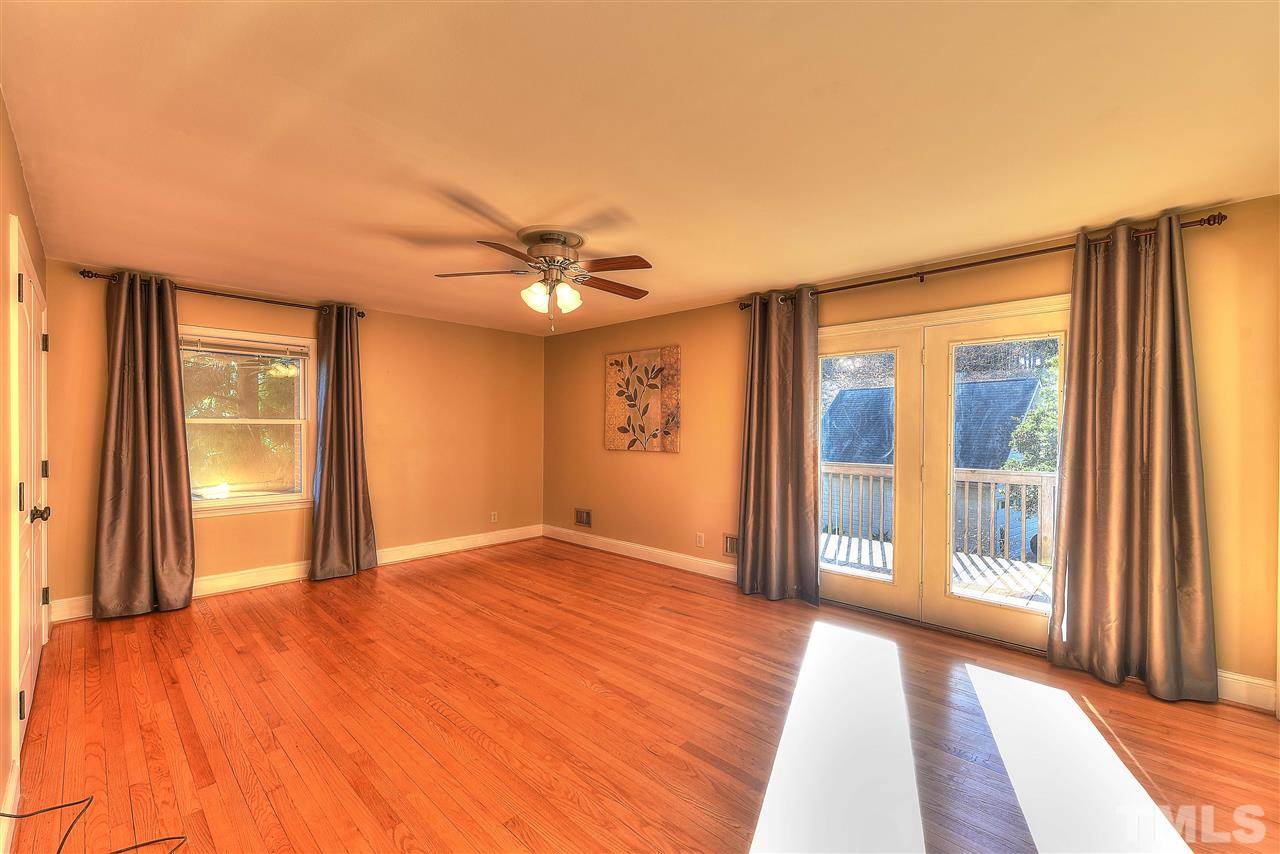 4217 Juniper Street Raleigh, NC 27612 - Photo 6 of 12 wooden floor in an empty room with a window