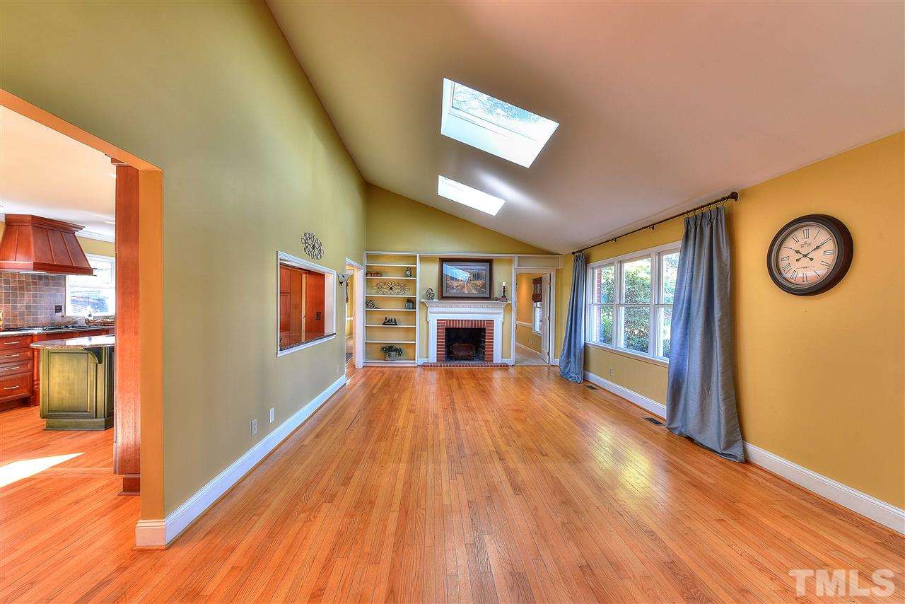 4217 Juniper Street Raleigh, NC 27612 - Photo 7 of 12 a view of an empty room with a window and wooden floor