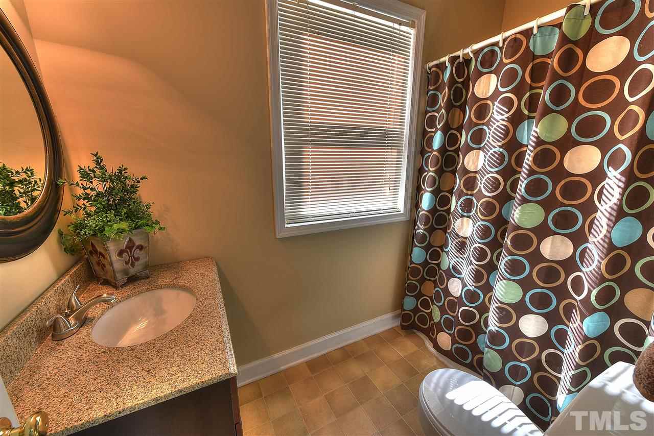 4217 Juniper Street Raleigh, NC 27612 - Photo 10 of 12 a bathroom with a sink toilet and a mirror